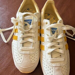 Adidas White Sneakers with Yellow Stripes